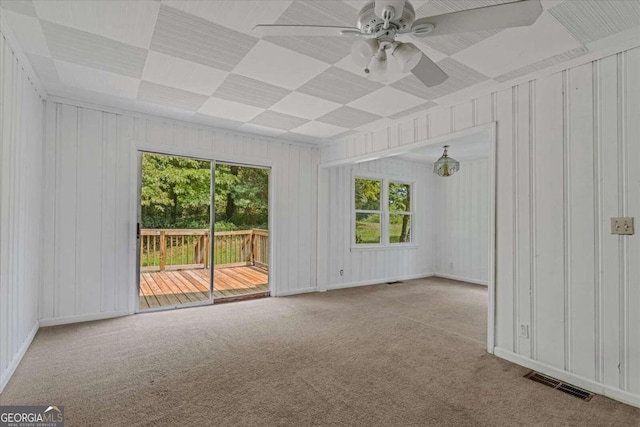 carpeted spare room with ceiling fan