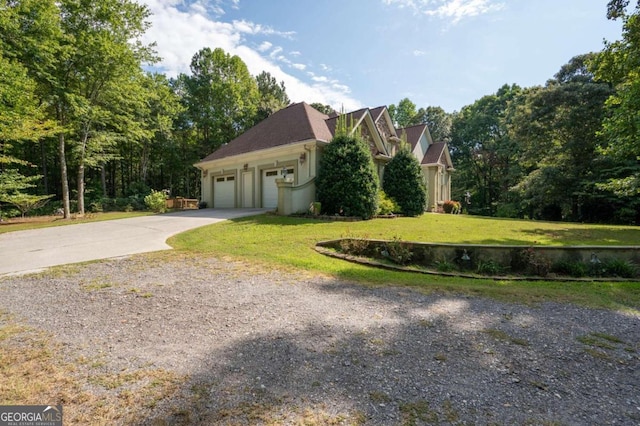 view of side of home featuring a garage and a yard