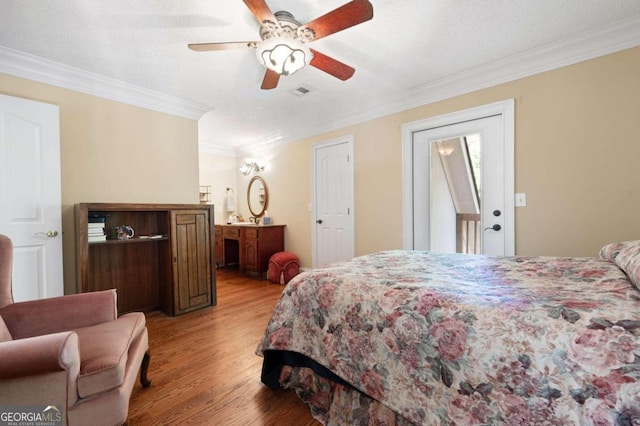 bedroom featuring ceiling fan, light hardwood / wood-style floors, and ornamental molding