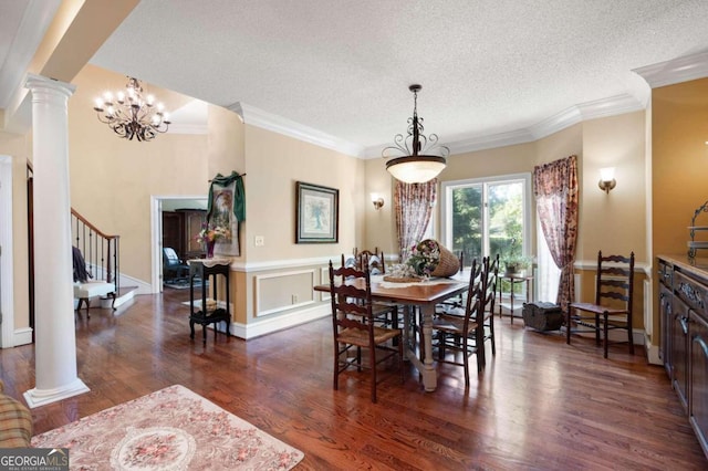 dining area with ornate columns, a textured ceiling, and dark hardwood / wood-style flooring