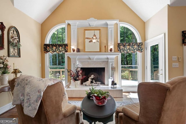 living room with a fireplace, plenty of natural light, and hardwood / wood-style floors