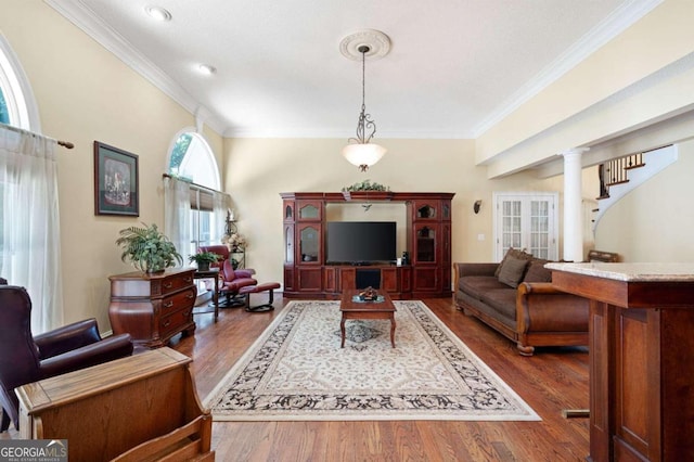 living room with ornamental molding, hardwood / wood-style floors, and ornate columns