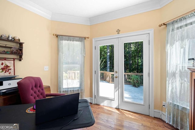 doorway with light hardwood / wood-style flooring, crown molding, and french doors