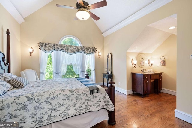 bedroom with ceiling fan, vaulted ceiling, and hardwood / wood-style flooring