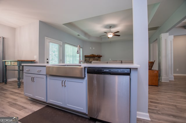 kitchen with light hardwood / wood-style flooring, dishwasher, ceiling fan, a raised ceiling, and white cabinets