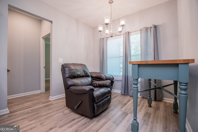 sitting room with an inviting chandelier and light hardwood / wood-style flooring