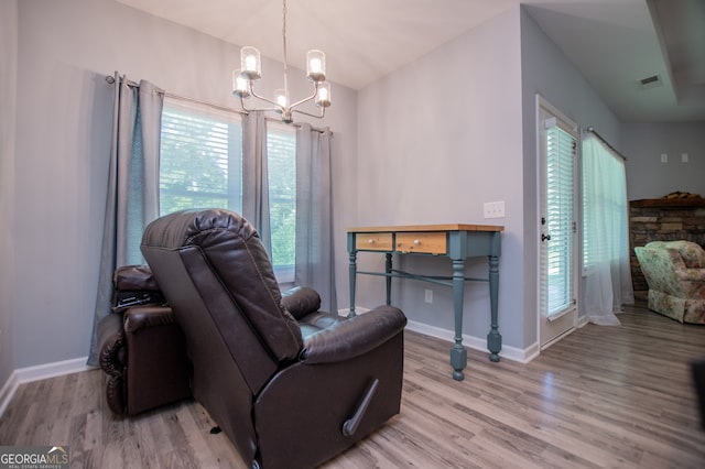 living room featuring vaulted ceiling, wood-type flooring, and plenty of natural light