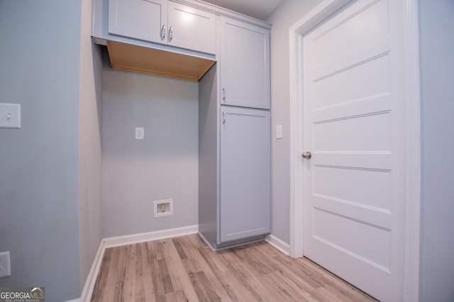 laundry area featuring light wood-type flooring and washer hookup