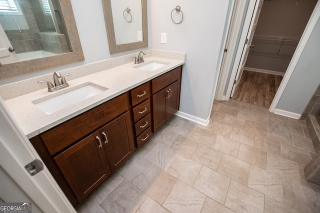 bathroom featuring double sink vanity and hardwood / wood-style floors