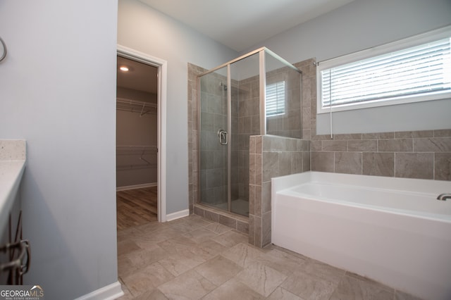 bathroom featuring independent shower and bath and tile patterned floors