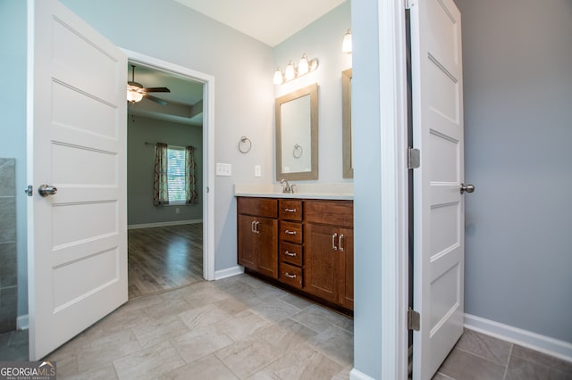 bathroom featuring ceiling fan, double vanity, and tile patterned flooring