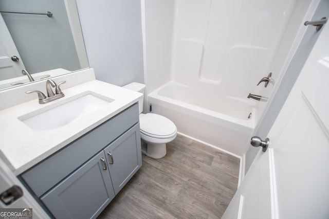 full bathroom featuring toilet, vanity, tub / shower combination, and wood-type flooring