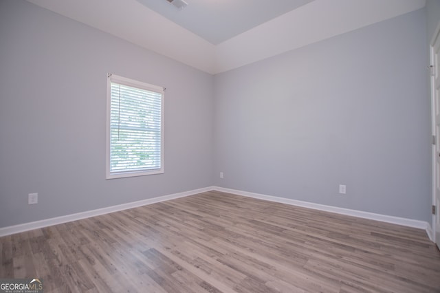 spare room with wood-type flooring