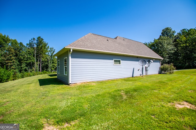 view of side of property with a yard