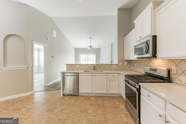 kitchen with backsplash, stainless steel appliances, ceiling fan, and light hardwood / wood-style floors