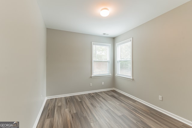 spare room with wood-type flooring