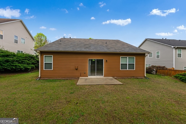 rear view of property with a patio area and a yard