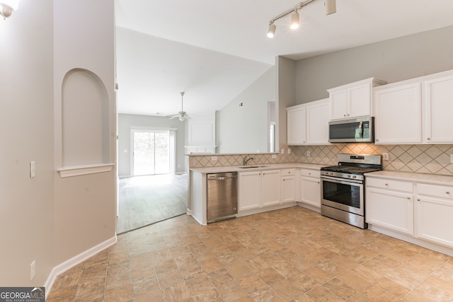 kitchen featuring stainless steel appliances, rail lighting, sink, light tile patterned floors, and ceiling fan