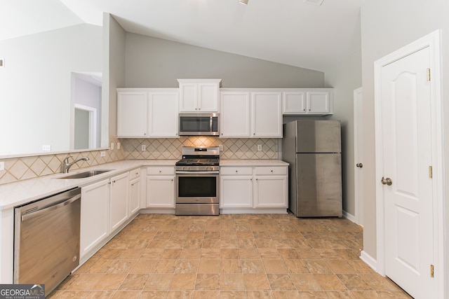 kitchen with sink, white cabinets, appliances with stainless steel finishes, and light tile patterned floors