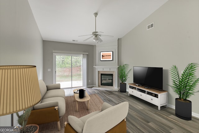 living room featuring ceiling fan, dark hardwood / wood-style floors, and vaulted ceiling