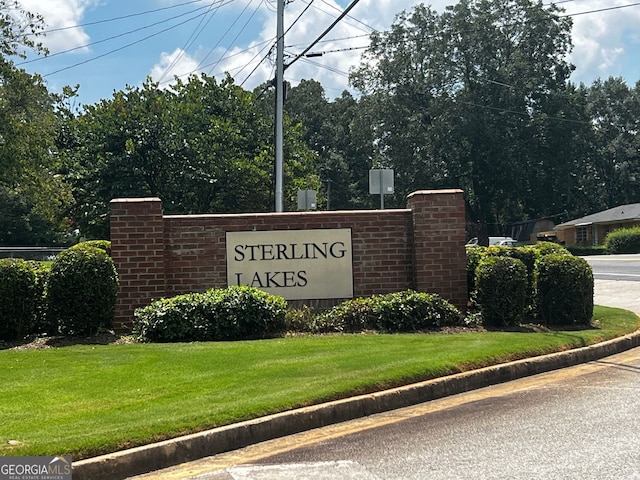 community sign featuring a lawn