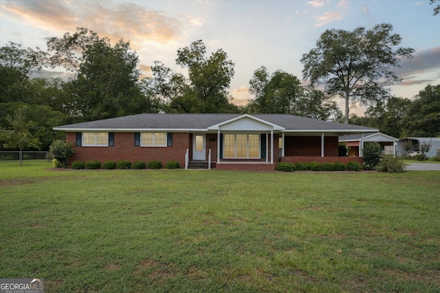 ranch-style house with a lawn