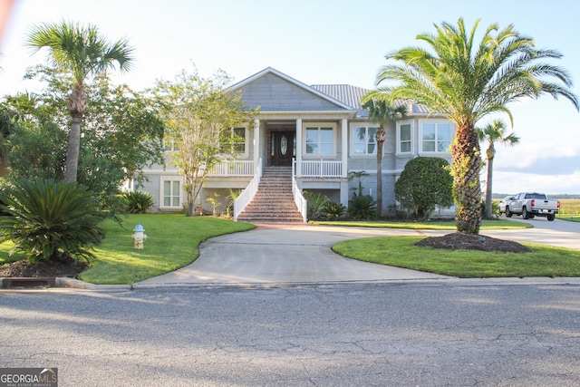 view of front of house with a front lawn and a porch