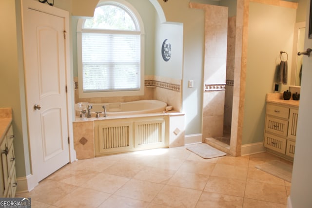 bathroom featuring tile patterned flooring, vanity, and separate shower and tub