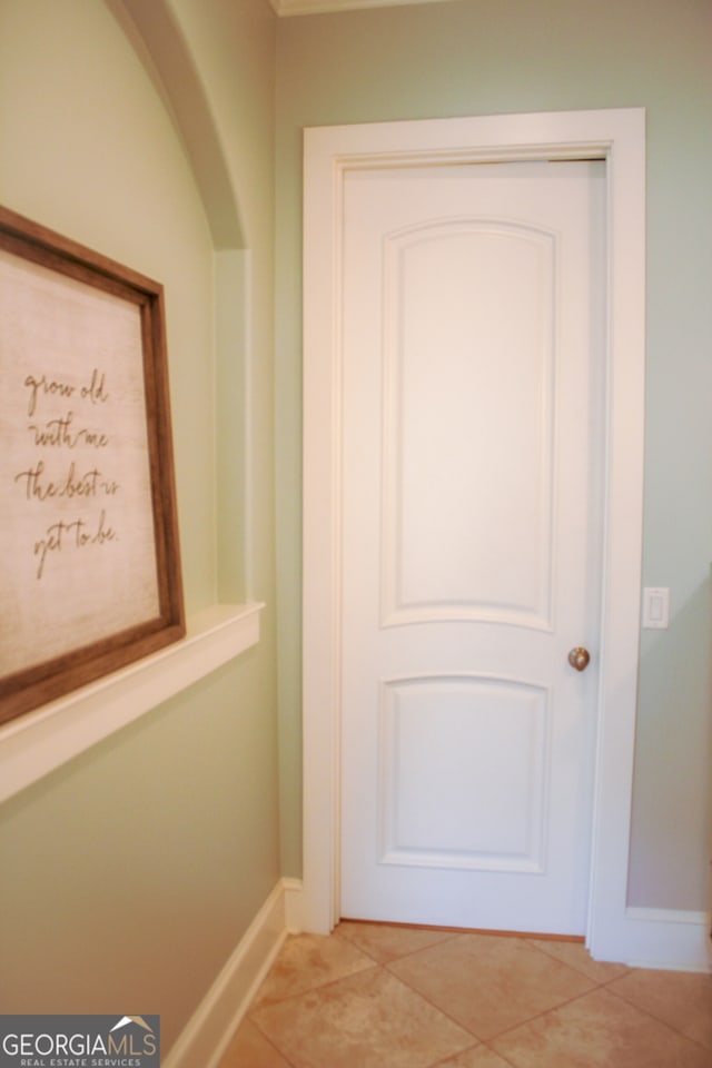 doorway with tile patterned flooring