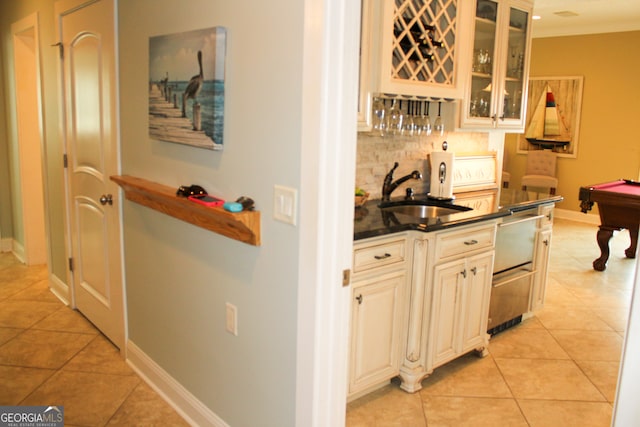 kitchen featuring decorative backsplash, sink, light tile patterned floors, and billiards