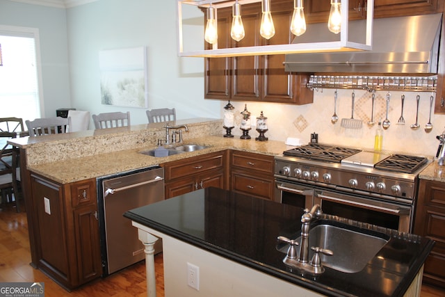 kitchen with a breakfast bar, wall chimney exhaust hood, stainless steel appliances, hardwood / wood-style floors, and light stone countertops