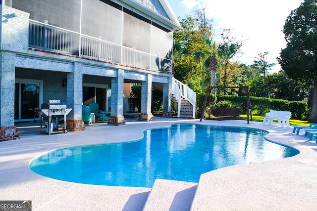 view of swimming pool with a patio area