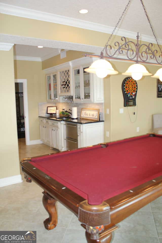 playroom with light tile patterned floors, ornamental molding, and pool table