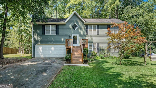 bi-level home with a garage and a front yard