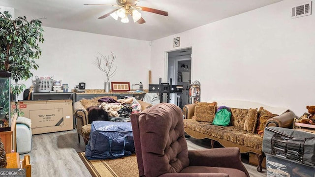 living room with ceiling fan and wood-type flooring