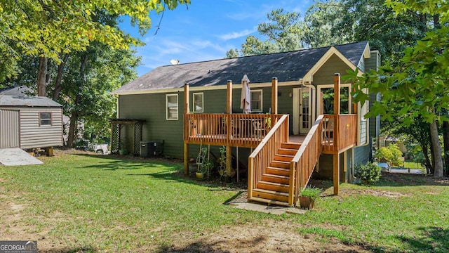 back of house with a storage unit, central air condition unit, a deck, and a yard