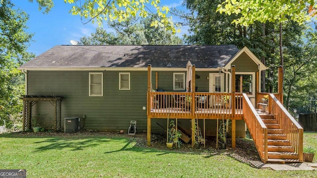 back of house with a wooden deck, central AC, and a lawn