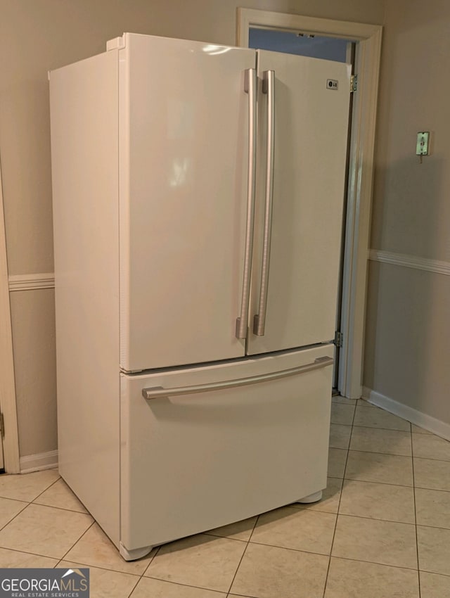 details featuring light tile patterned flooring and high end fridge