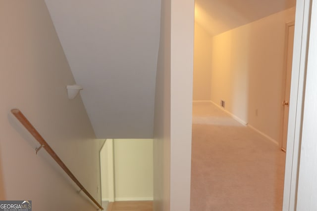 staircase with carpet and vaulted ceiling