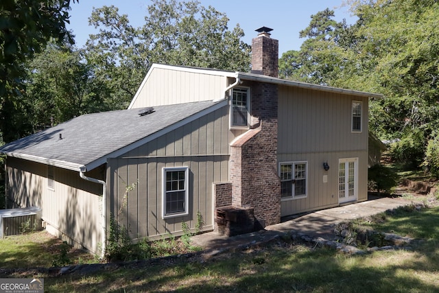 rear view of property with a patio, french doors, and cooling unit