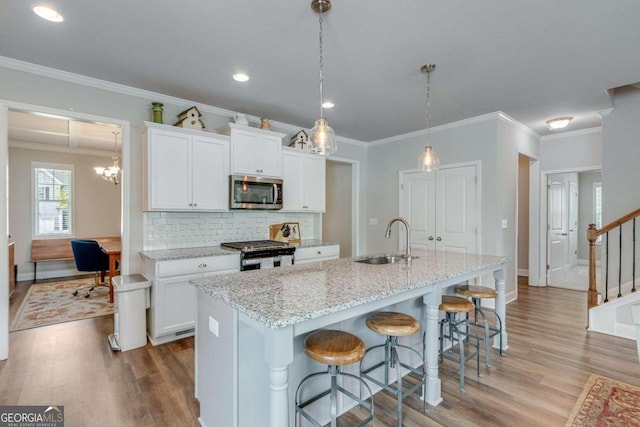 kitchen featuring sink, white cabinetry, appliances with stainless steel finishes, and wood-type flooring