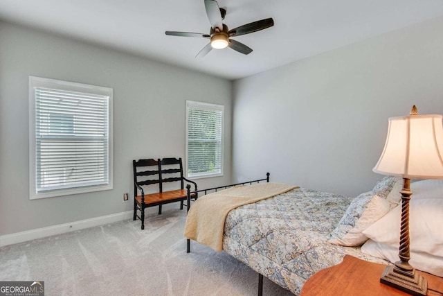 bedroom featuring ceiling fan and light carpet