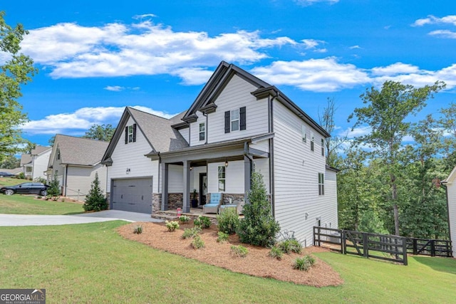 view of front of house with a porch, a garage, and a front lawn