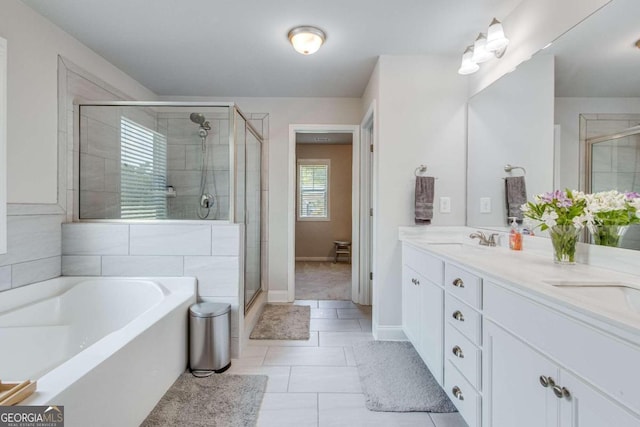 bathroom with double vanity, separate shower and tub, and tile patterned floors