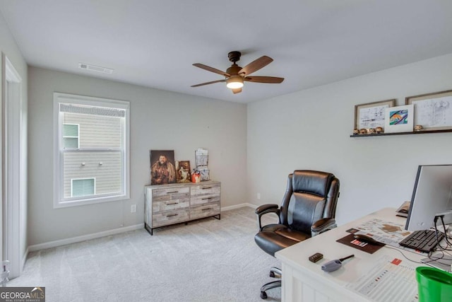 carpeted office featuring ceiling fan