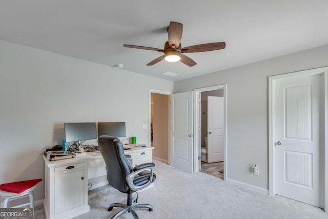 home office featuring ceiling fan and light carpet