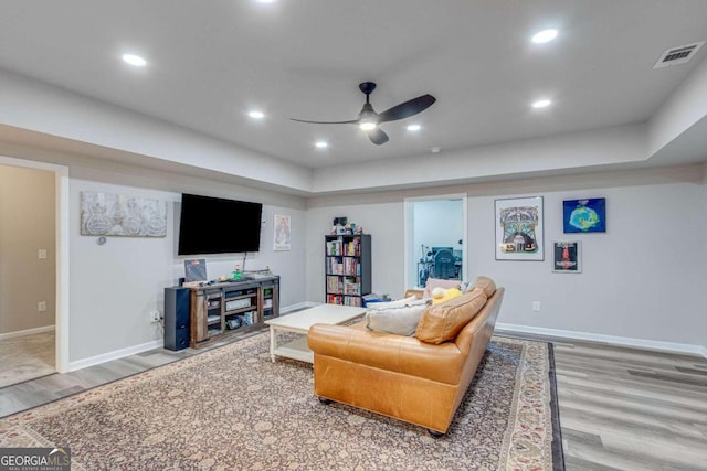 living room with ceiling fan and wood-type flooring