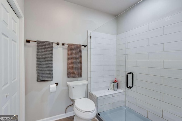 bathroom featuring walk in shower and toilet