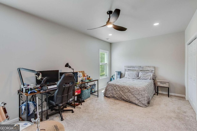 carpeted bedroom with ceiling fan and a closet