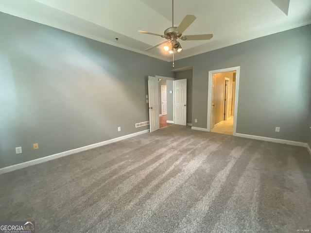 unfurnished bedroom with carpet floors, connected bathroom, ceiling fan, and lofted ceiling